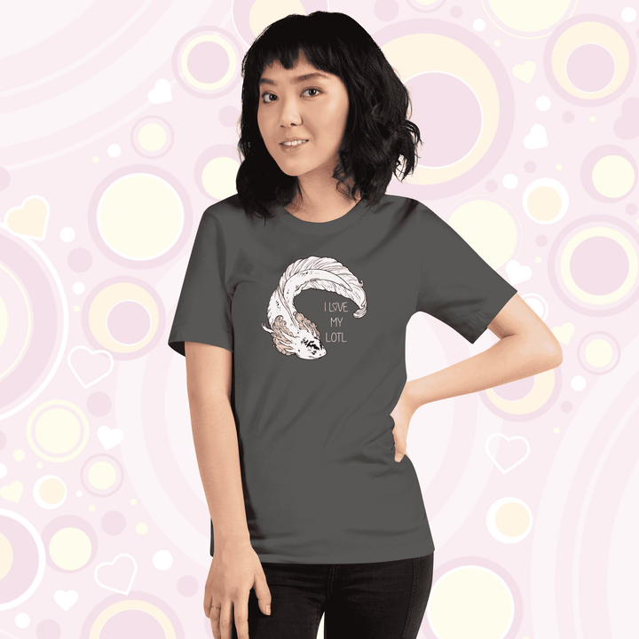 Lady wearing asphalt grey crew neck tee with a white axolotl with black speckles on it's nose and pink gills that have very delicate line art on it. There is text that reads I love my lotl.