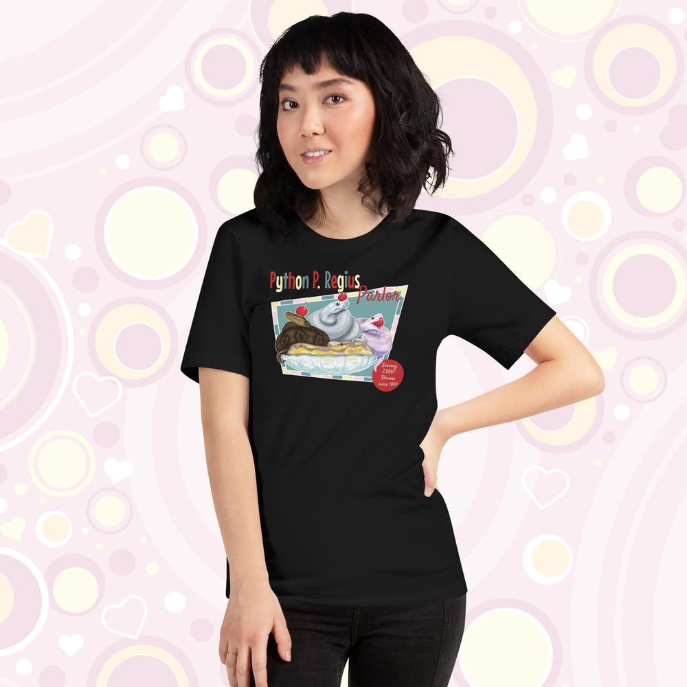 Lady wearing a black crew neck tee showing a retro style design of 4 ball pythons in a banana split boat; one representing chocolate, strawberry, and vanilla ice cream and each topped with a sweet cherry! The text Python P Regius is on top in multi colors.