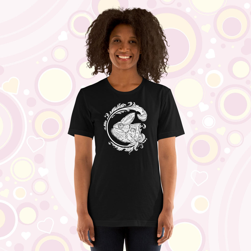 Lady wearing black crew neck tee of a black and white veiled chameleon surrounded by a beautiful flourish design.