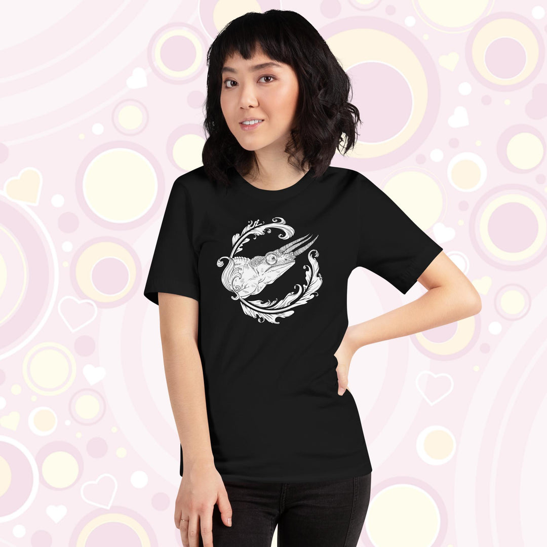 A lady wearing a black crew neck tee with a black and white design of a jackson's chameleon and a round elegant flourish surrounding the reptile.