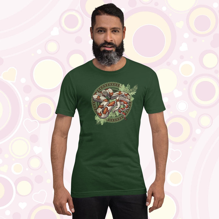 Man wearing forest colored crew neck tee showing a red tailed boa constrictor in the center of a westernish patterned design with simple leaf graphics under the boa.