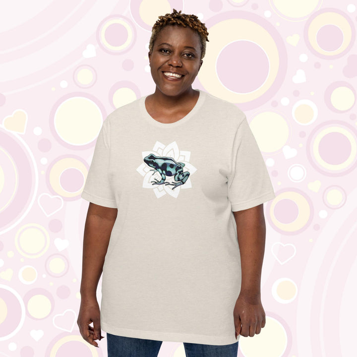 Plus sized woman wearing heather dust crew neck tee with a black and teal poison dart from resting on a simple white floral design.