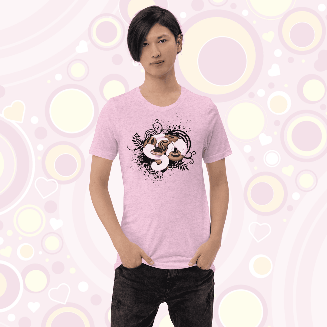 Young adult wearing heather prism lilac colored crew neck tee with a pied ball python graphic with simple black swirls, leaves, and spatter marks behind it.