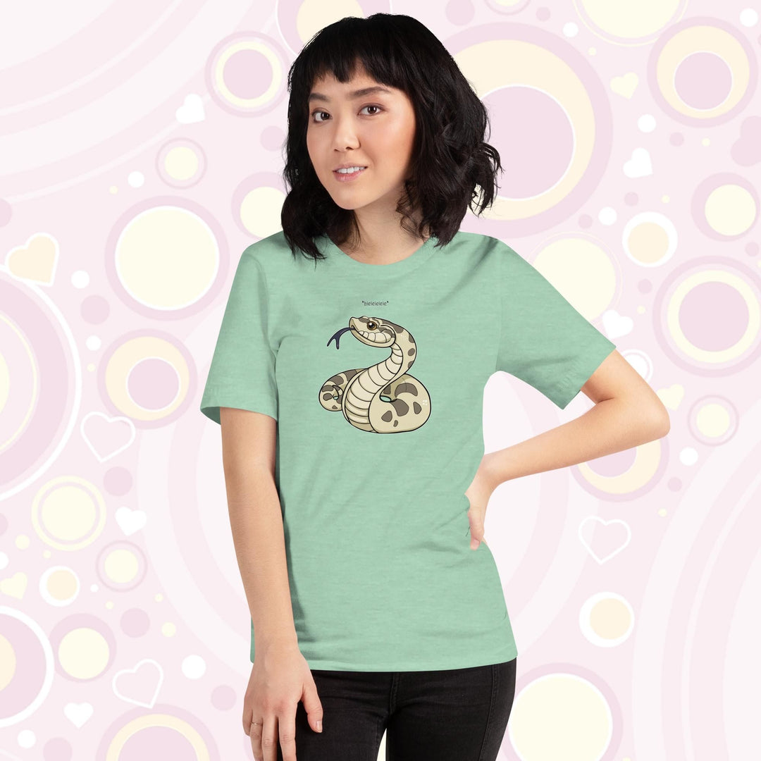 Lady wearing heather prism mint colored crew neck tee with a simple cartoony silly hognose flicking out it's tongue and saying "blelele".