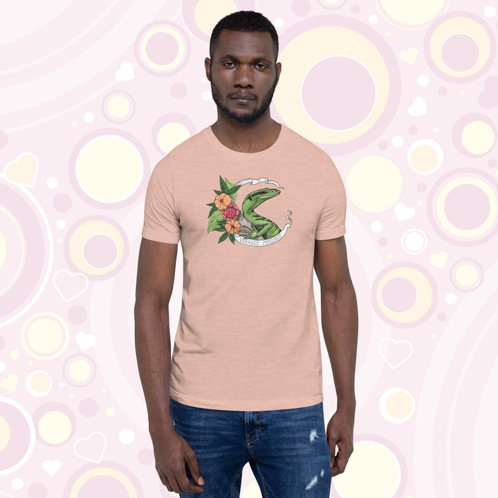 Man wearing heather prism peach crew neck tee with a emerald tree monitor lizard in the center of a white banner with the species name on it and orange and pink flowers on the side.