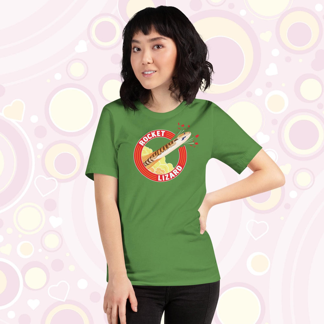 Lady wearing green crew neck tee with a circular design stating Rocket Lizard on the top and bottom and a cartoon blue tongue skink lizard blasting out from the side.