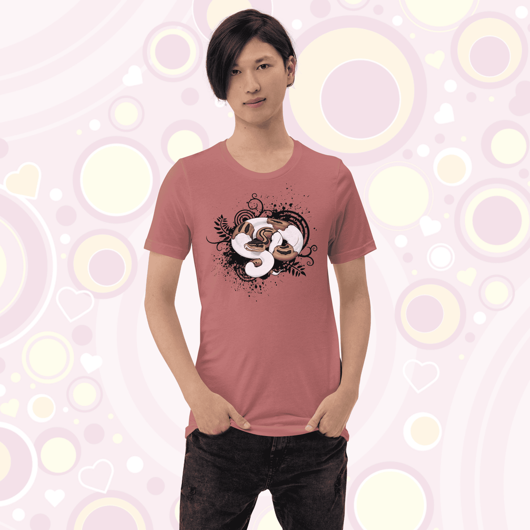 Young adult wearing mauve colored crew neck tee with a pied ball python graphic with simple black swirls, leaves, and spatter marks behind it.