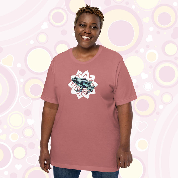 Plus sized woman wearing mauve crew neck tee with a black and teal poison dart from resting on a simple white floral design.