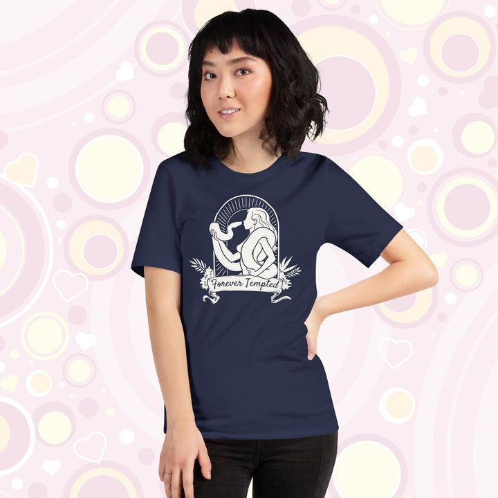 A lady wearing a navy crew neck tee with a silhouette of a woman holding a snake and text saying "Forever Tempted".