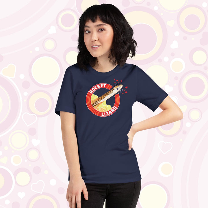 Lady wearing navy crew neck tee with a circular design stating Rocket Lizard on the top and bottom and a cartoon blue tongue skink lizard blasting out from the side.