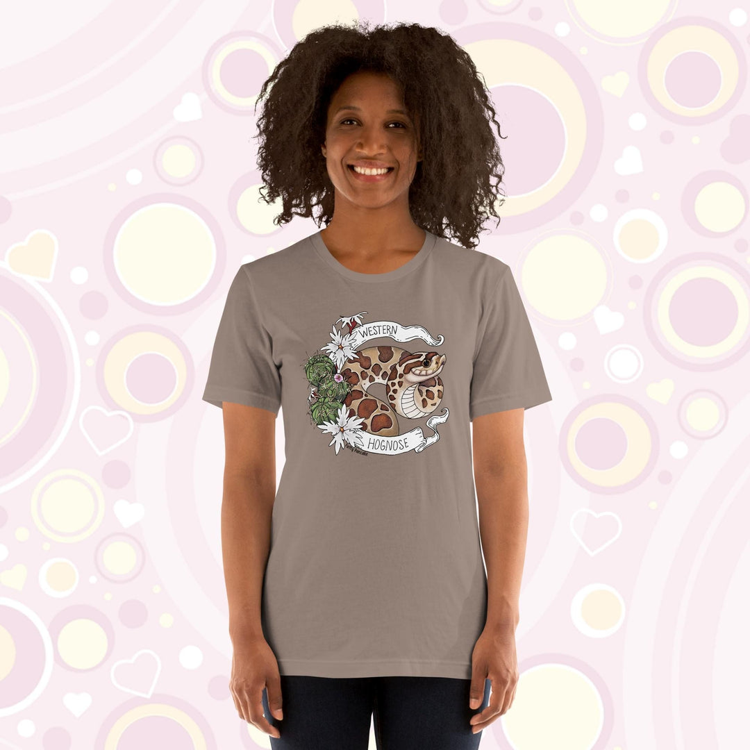 Image shows a woman wearing a pebble brown crew neck tee with a western hognose graphic framed with cactus and white flowers and a banner that has the text, "Western Hognose" on it.