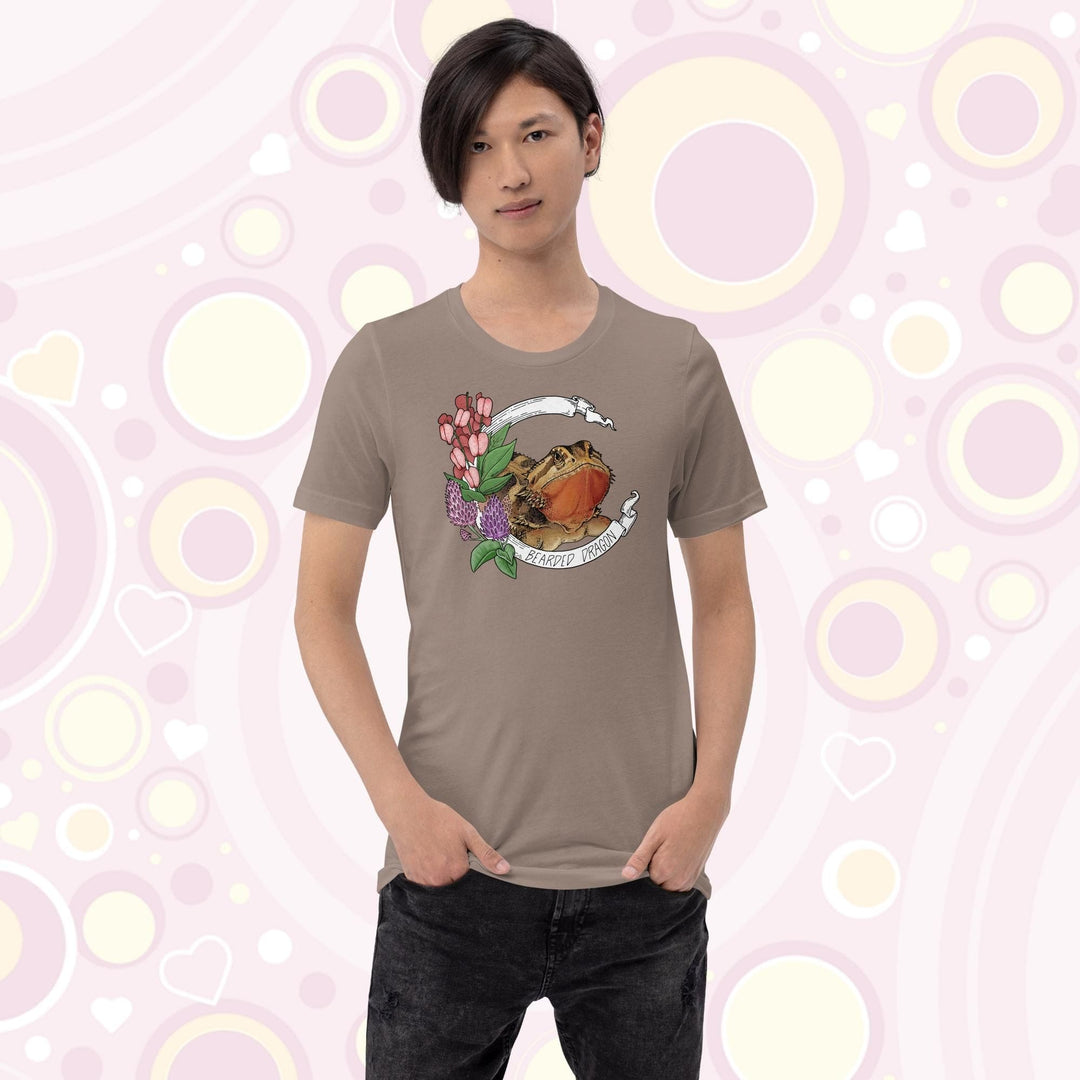 Image of a youth wearing a pebble brown colored crew neck tee with a bearded dragon on it. The beardie is framed by a white banner with the text, "Bearded dragon" on the bottom and purple and red flowers adorning the left side of the design.