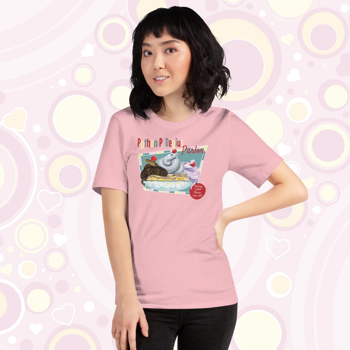 Lady wearing a pink crew neck tee showing a retro style design of 4 ball pythons in a banana split boat; one representing chocolate, strawberry, and vanilla ice cream and each topped with a sweet cherry! The text Python P Regius is on top in multi colors.