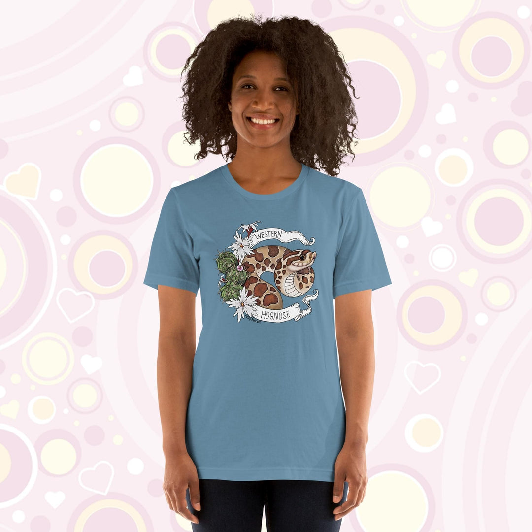 Image shows a woman wearing a steel blue crew neck tee with a western hognose graphic framed with cactus and white flowers and a banner that has the text, "Western Hognose" on it.