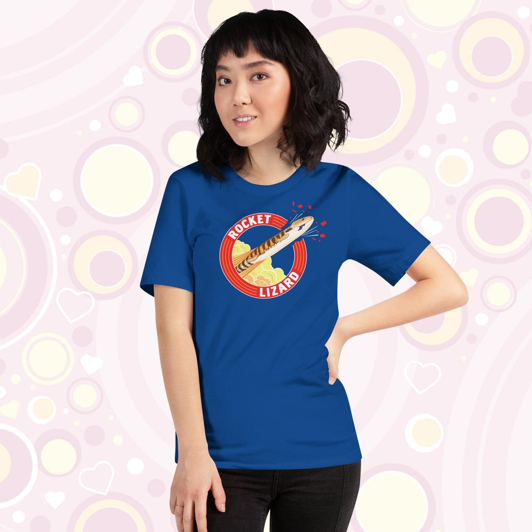 Lady wearing blue crew neck tee with a circular design stating Rocket Lizard on the top and bottom and a cartoon blue tongue skink lizard blasting out from the side.