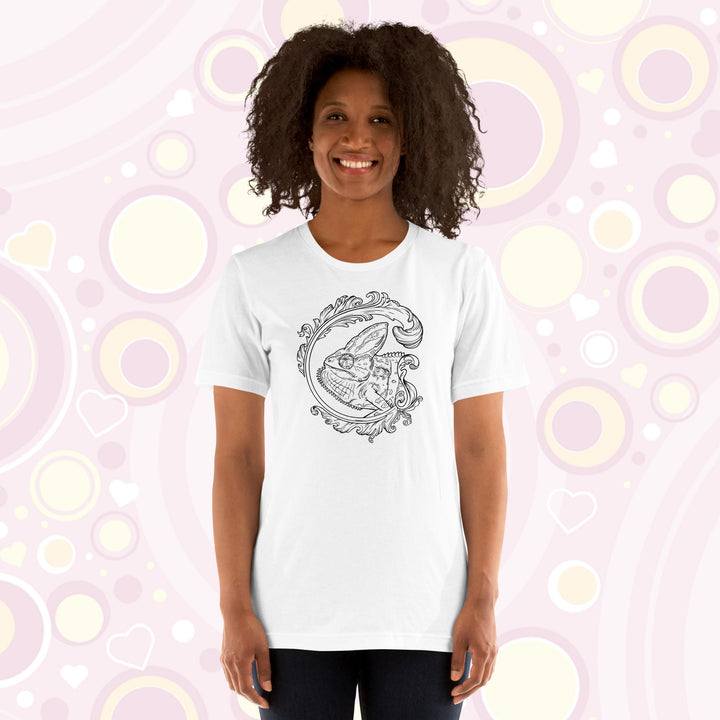 Lady wearing white crew neck tee of a black and white veiled chameleon surrounded by a beautiful flourish design.