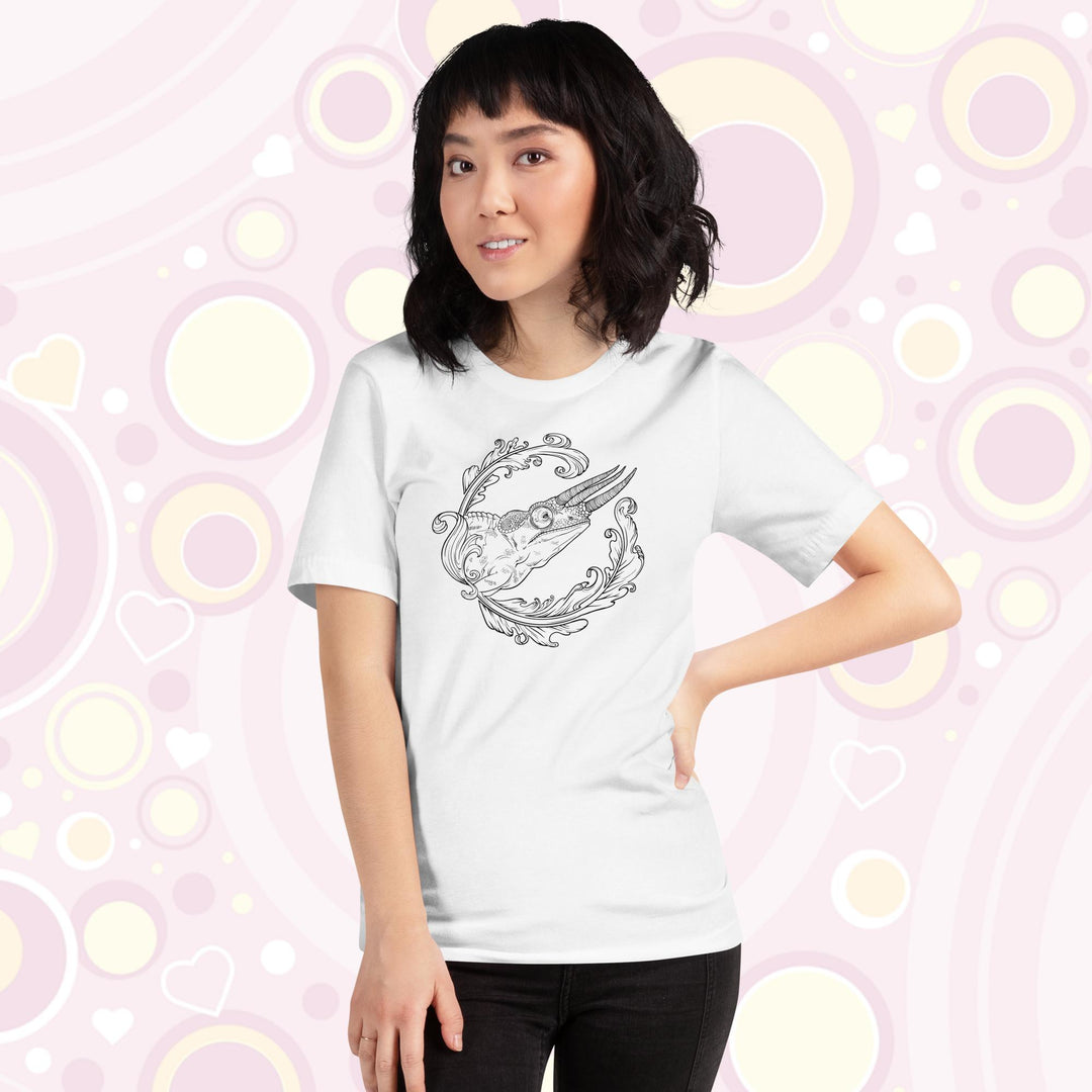 A lady wearing a white crew neck tee with a black and white design of a jackson's chameleon and a round elegant flourish surrounding the reptile.