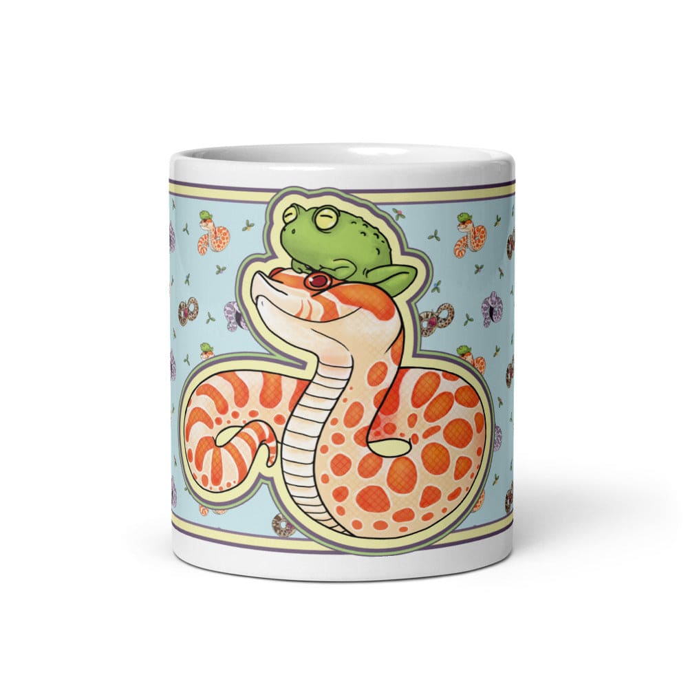Image of a 11oz mug with a graphic showing the front side of the hognose with frog design. The background color is blue with lots of other hognose snakes and flowers surrounding it.