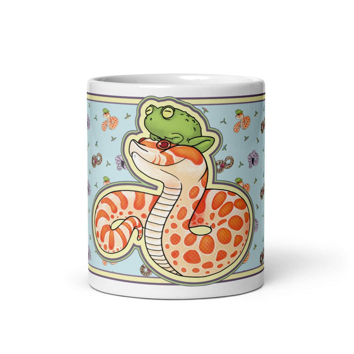 Image of a 11oz mug with a graphic showing the front side of the hognose with frog design. The background color is blue with lots of other hognose snakes and flowers surrounding it.
