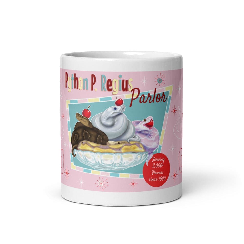 A white 11oz ceramic mug featuring a pink background with a graphic of three snakes in a glass bowl topped with cherries. The text reads Python P. Regius Parlor and Serving 2,000+ Flavors since 1900, accented with small starburst shapes.