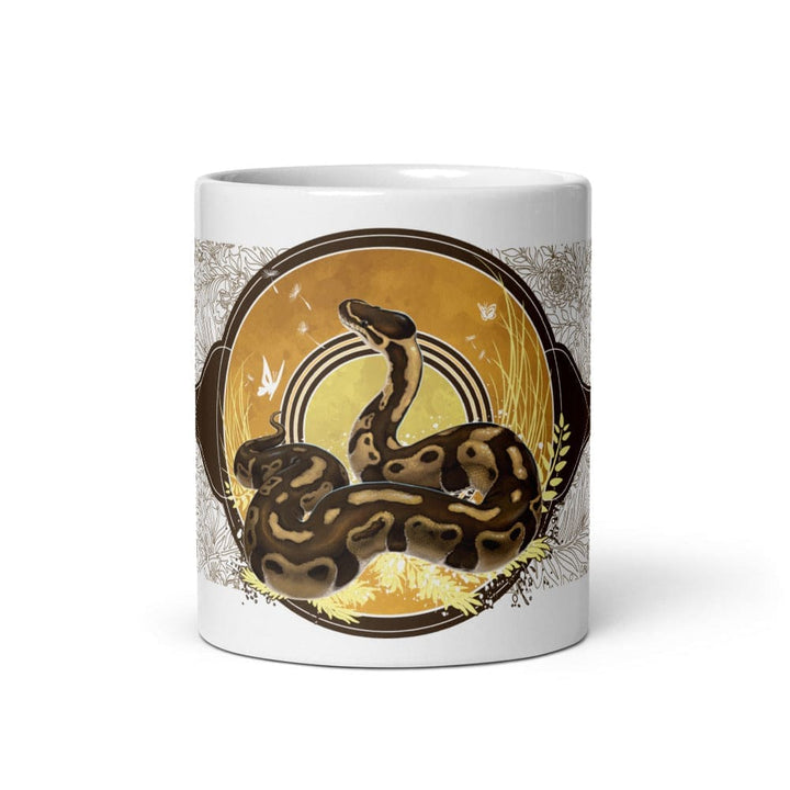 A white 11oz mug of a normal phase ball python with gold and warm colors in a autumn like setting sitting on a white background. 