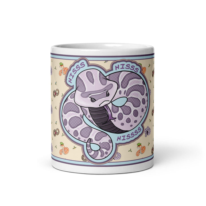Front side of the 11oz Hognose Hiss Hiss Hiss mug. The mug has a full color wrap with some white ceramic on the handle and top and bottom. The design is cute, cartoony, with a lavender angry hoggie hissing dramatically against a pale yellow background with tiny hognoses and flowers.