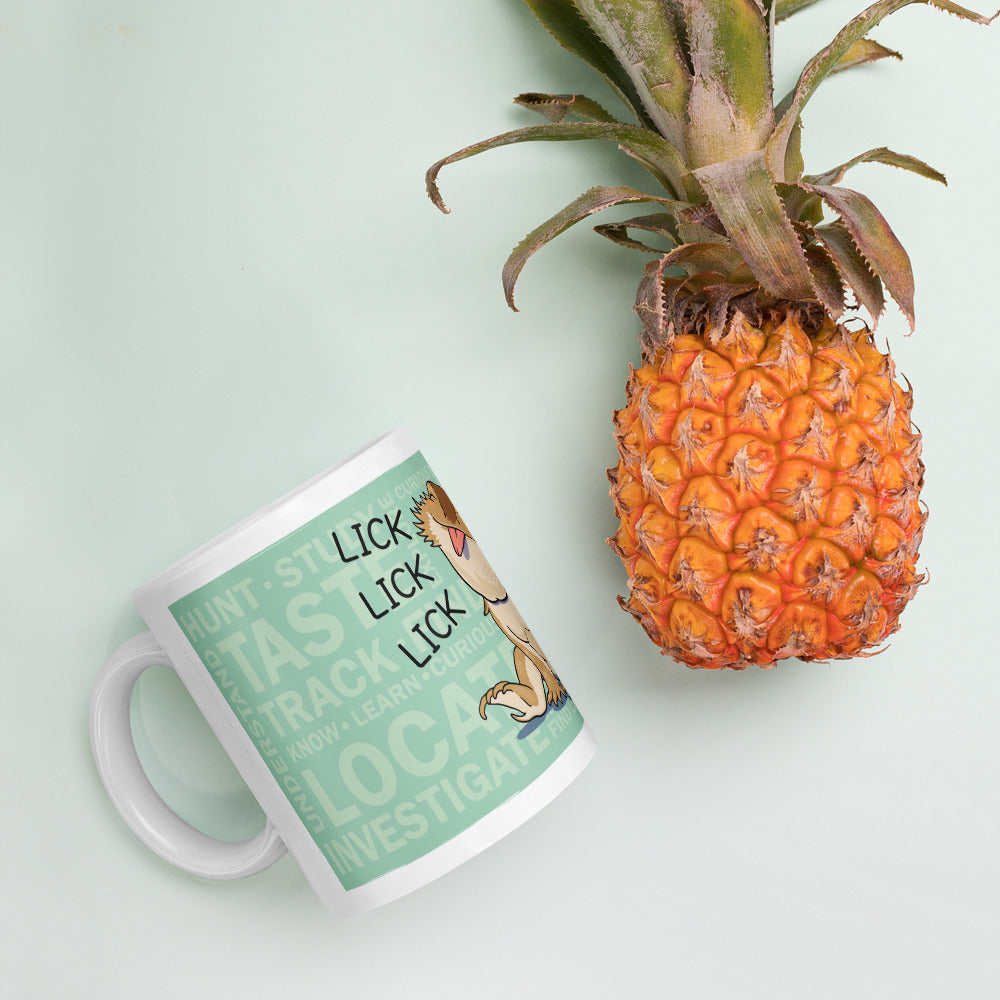 A white ceramic mug with a mint green graphic design featuring the text &