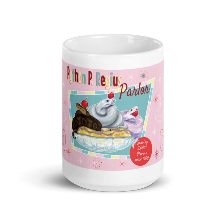 A white 15oz ceramic mug featuring a pink background with a graphic of three snakes in a glass bowl topped with cherries. The text reads Python P. Regius Parlor and Serving 2,000+ Flavors since 1900, accented with small starburst shapes.