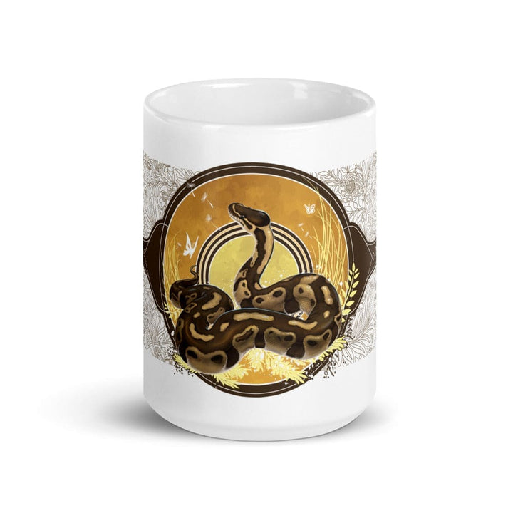 A white 15oz mug of a normal phase ball python with gold and warm colors in a autumn like setting sitting on a white background. 