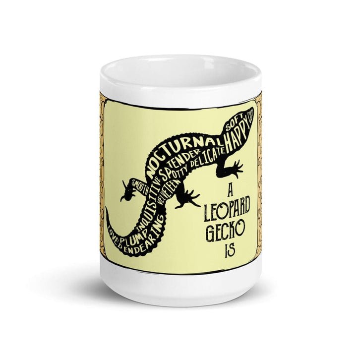 A white 15oz ceramic mug featuring a central pale yellow rectangular panel with a black silhouette of a leopard gecko. The gecko&