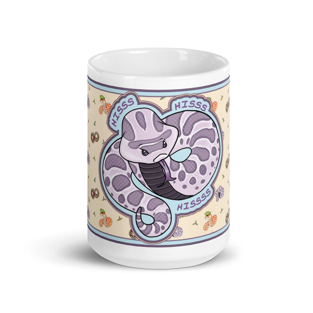 Front side of the 15oz Hognose Hiss Hiss Hiss mug. The mug has a full color wrap with some white ceramic on the handle and top and bottom. The design is cute, cartoony, with a lavender angry hoggie hissing dramatically against a pale yellow background with tiny hognoses and flowers.