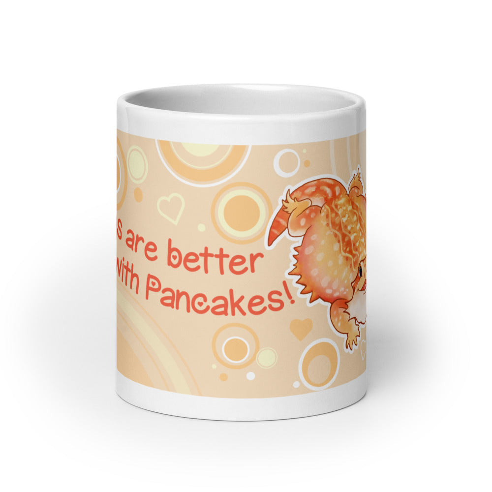 A white ceramic mug featuring a cute orange cartoon bearded dragon lizard character and the text &
