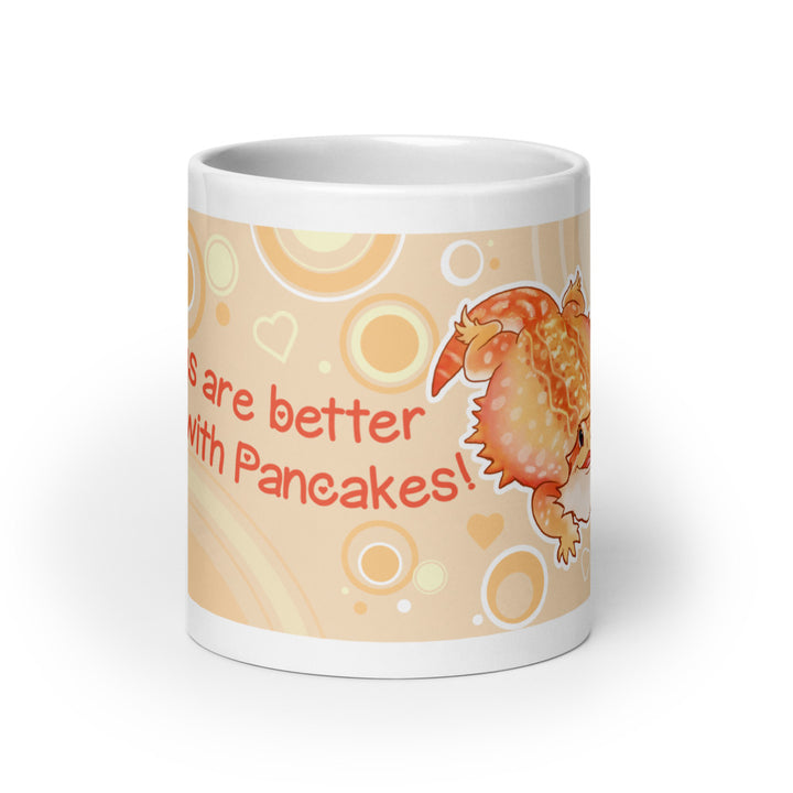 A white ceramic mug featuring a cute orange cartoon bearded dragon lizard character and the text &