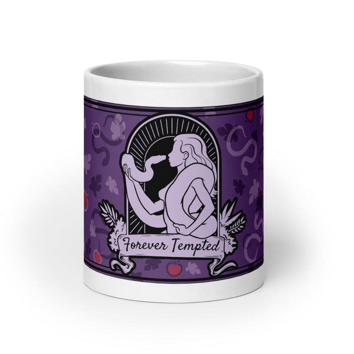 A 20oz white ceramic mug featuring a purple graphic illustration of a figure holding a snake within an arched frame. The text Forever Tempted is printed on a banner below the figure, surrounded by a pattern of leaves and red apples.
