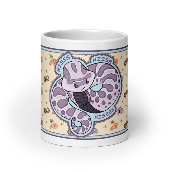 Front side of the 20oz Hognose Hiss Hiss Hiss mug. The mug has a full color wrap with some white ceramic on the handle and top and bottom. The design is cute, cartoony, with a lavender angry hoggie hissing dramatically against a pale yellow background with tiny hognoses and flowers.
