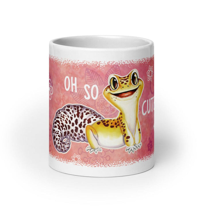 A white ceramic mug featuring a pink wraparound design with a cartoon leopard gecko and the text &