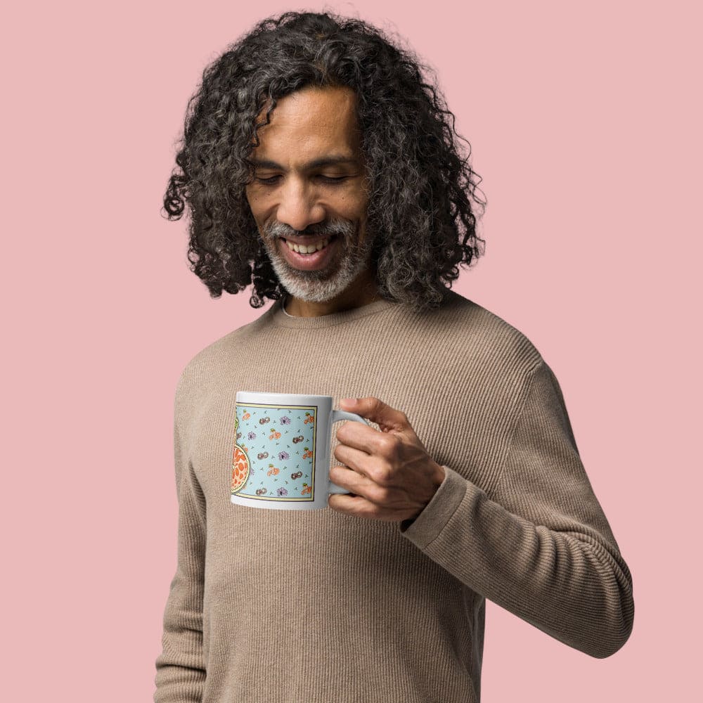 Man holding a mug with an albino hognose snake with a frog on it's head with a blue wrapped image with tiny hognose snakes arranged in a pattern. It is a cute, light hearted, cartoon design.